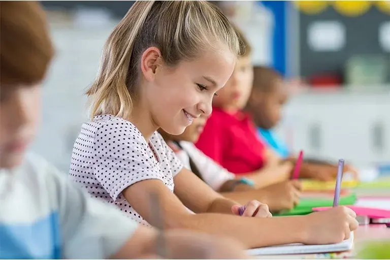 Happy_girl_working_at_desk